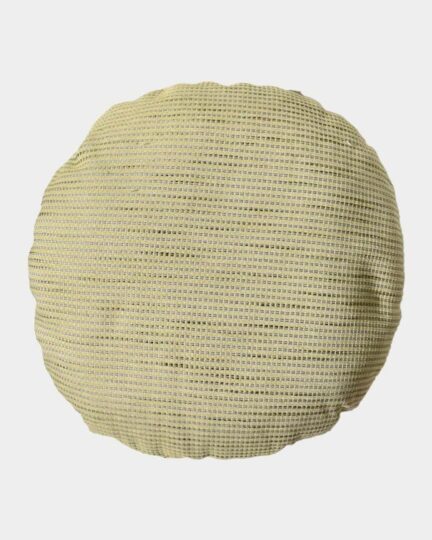 Almohadón redondo TRIM by ONYX. Foto en en estudio desde arriba.